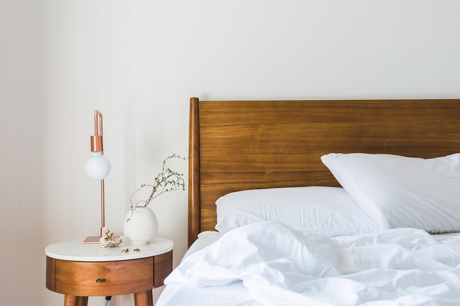 Minimalistic bed with white bed linen